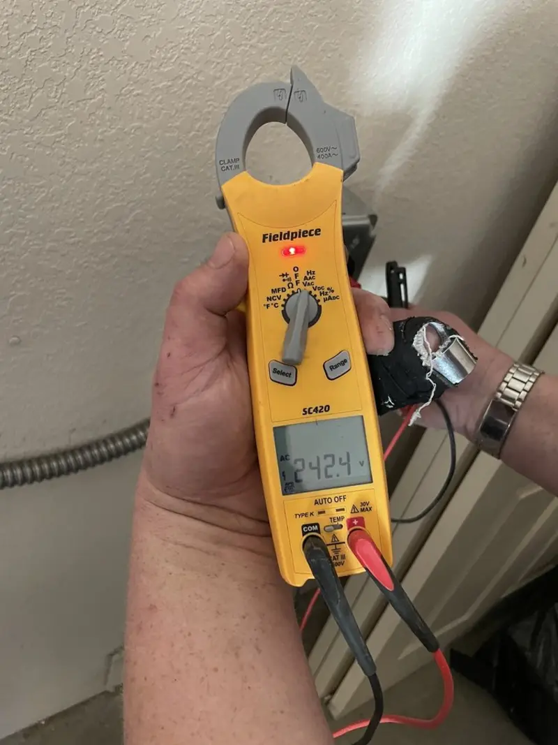 Voltage testing with clamp meter during Ceiling Fan Installation in St. Simons